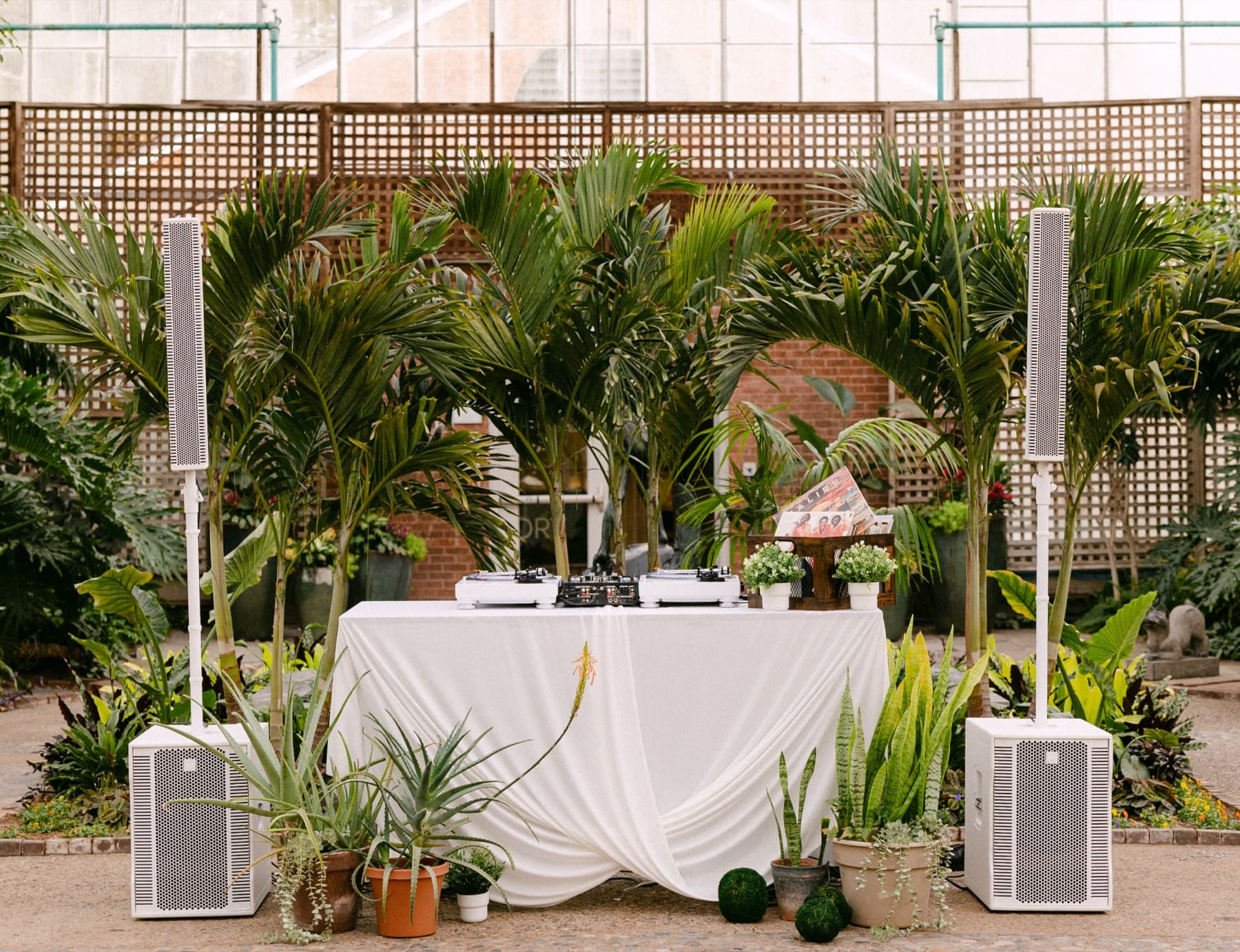 White fabric draped DJ table with white speakers
